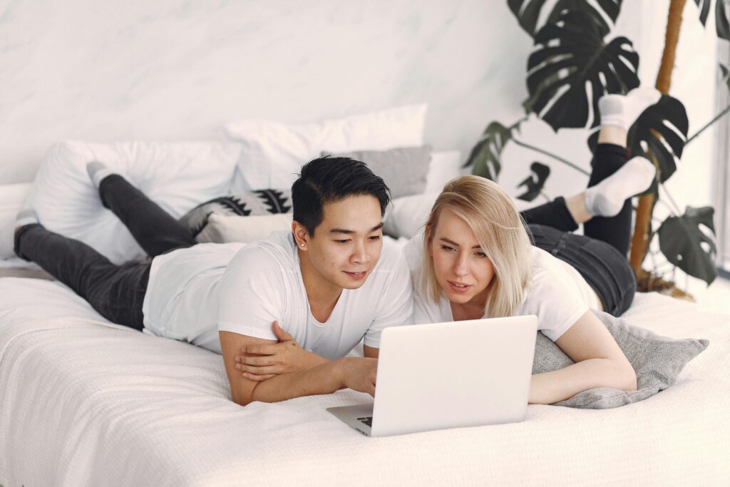 pexels photo 3912397 3912397 Young couple enjoying leisure time together streaming videos on a laptop in a cozy, modern bedroom.